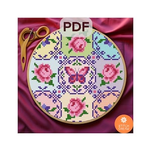 May include: A cross-stitch pattern in a wooden embroidery hoop, featuring a floral design with pink roses and a butterfly. The pattern is in a patchwork style with pastel colors. The text "PDF" is in the upper center. The logo "Stitch Dream" is in the lower right.