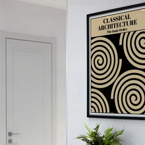 May include: A framed art print with the text "CLASSICAL ARCHITECTURE The Ionic Order." The artwork features a black background with beige spiral designs. The frame is black, and the print is displayed on a white wall.