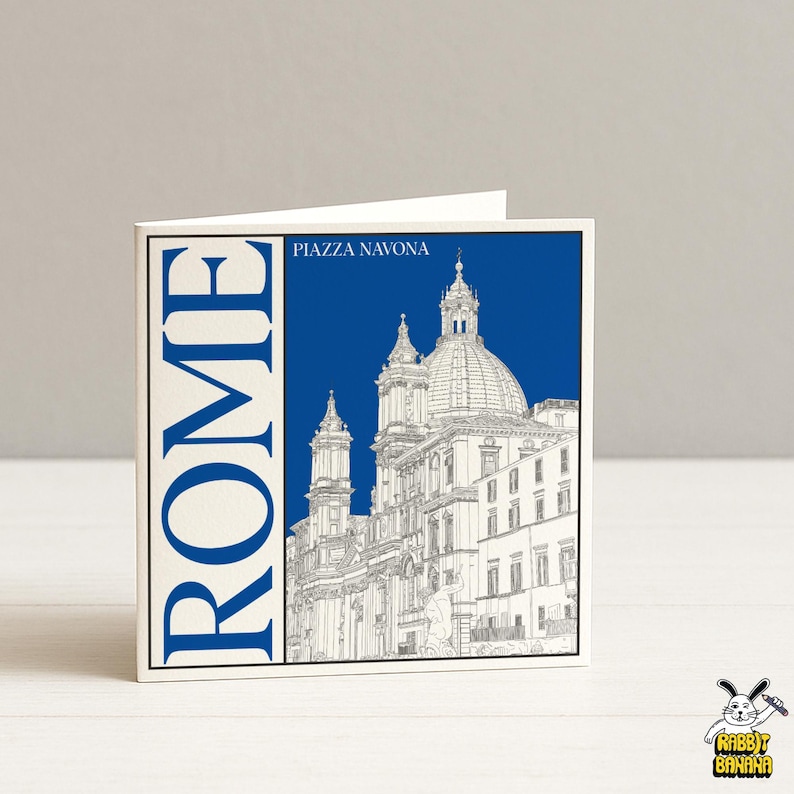 May include: A folded greeting card featuring a blue and white illustration of Piazza Navona in Rome. The word "ROME" is printed vertically in blue on the left side. The text "PIAZZA NAVONA" is above the illustration.
