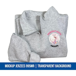 May include: A light gray mock-up of a quarter-zip sweatshirt with a silver zipper. The sweatshirt has a round logo with the text "WILDCRAFT DIGITAL MOCKUPS" and a fairy illustration. The bottom of the image has the text "MOCKUP JERZEES 995MR | TRANSPARENT BACKGROUND".