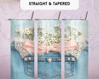 May include: A 20 oz tumbler wrap with a design featuring a denim pocket, white daisies, a pink bow, and lace trim. The tumbler has a silver lid and a straw. The text "20 OZ TUMBLER WRAP STRAIGHT & TAPERED" is at the top.
