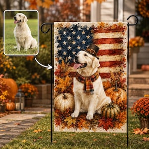 May include: A rectangular garden flag featuring a golden retriever wearing a top hat and a plaid scarf, sitting amidst pumpkins and autumn leaves against a backdrop of the American flag. An inset shows the dog sitting on a grassy lawn.