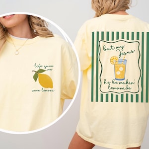 May include: Light yellow t-shirt with the text "life gave me some lemons" and a lemon graphic on the front. The back of the shirt features the text "but my Jesus he be makin' lemonade" with a lemonade graphic.