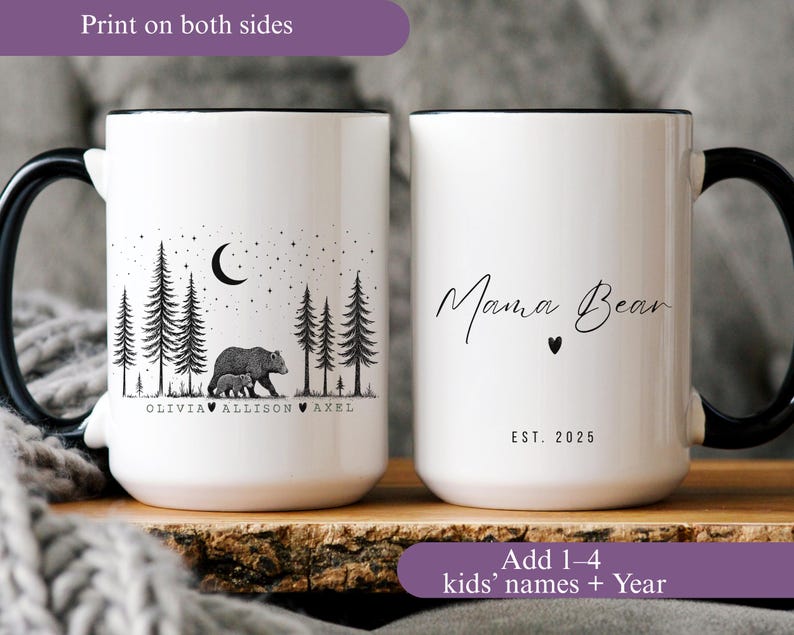 May include: White ceramic mug with a black handle and rim. One side features a bear and cub in a forest scene with names below. The other side says "Mama Bear" with a heart and "EST. 2025".