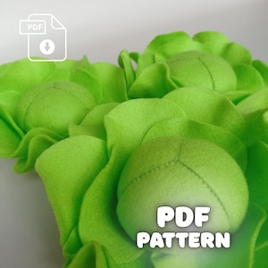 May include: A close-up of a felt craft project in shades of green, resembling a head of lettuce. The text "PDF PATTERN" is overlaid on the image. The image also includes a PDF icon.