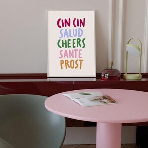 May include: A white ceramic mug with a black handle and the text "But First, Coffee" in a black, handwritten-style font. The mug is on a white surface.