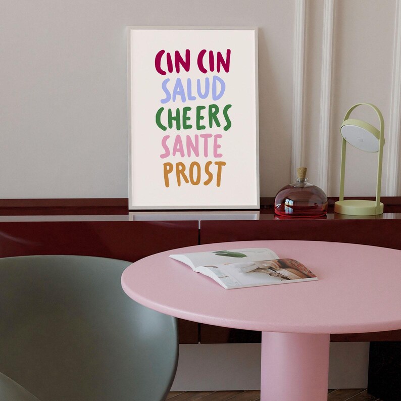 May include: A white ceramic mug with a black handle and the text "But First, Coffee" in a black, handwritten-style font. The mug is on a white surface.