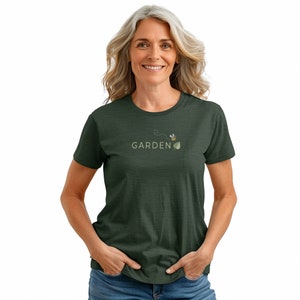 Woman wearing the Bee Leaf tee, size small, in color heather forest.