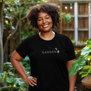 The Garden Belief t-shirt really pops in black! The model is wearing a size 2XL.
