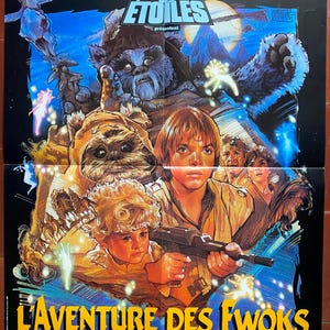 May include: A vintage movie poster for the film "The Ewok Adventure", featuring a colorful illustration of characters from the Star Wars universe. The poster features the text "Les créateurs de la trilogie" and "GUERRE DES ETOILES" in French.