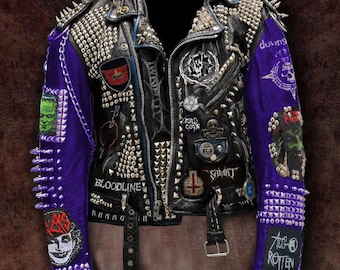 May include: A black leather jacket with silver studs and spikes. The jacket has purple sleeves with various patches, including "Bloodline", "Too Rotten", and "Smart".