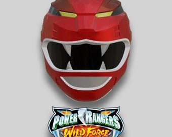 May include: A red Power Rangers Wild Force helmet with a white mouth and black eye openings. The helmet has yellow accents and a stylized design. Below the helmet is the Power Rangers Wild Force logo.