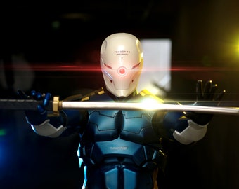 May include: A cyborg figure wearing a white helmet with the text "TOKUgawa HEAVY INDUSTRY" and a red visor. The figure is holding a silver sword and has a blue and silver metallic body.