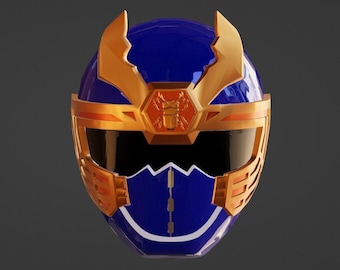 May include: A blue and gold helmet with a black visor. The helmet features gold accents, including a band across the forehead, side panels, and decorative elements on top. A gold emblem of an insect is centered on the forehead.