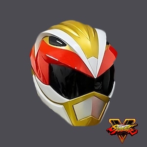 May include: A red, white, and gold helmet with a black visor. The helmet has a stylized design with sharp angles and a gold chin guard. The Street Fighter V logo is visible in the lower right corner.