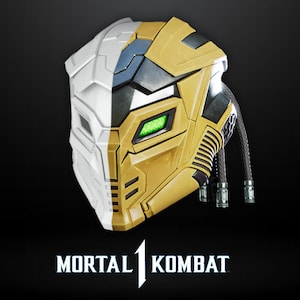 May include: A two-tone mask, half white and half gold, with a green rectangular eye. The mask has a futuristic design with black accents and braided tubes. The "Mortal Kombat" logo is at the bottom.