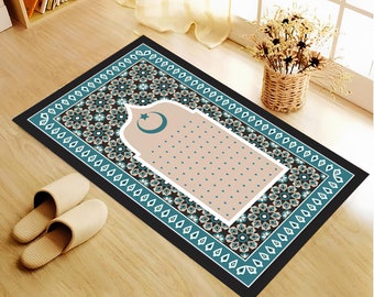 May include: A rectangular prayer rug with a black border, teal and white geometric patterns, and a central beige area. The rug features a design with a crescent moon and star. Two beige slippers are on the floor.