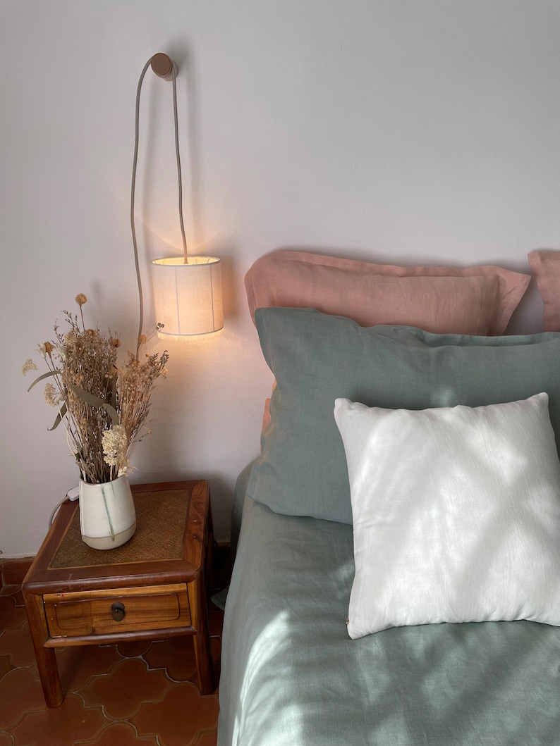 Ivory linen portable lamp. The delicacy of washed linen is found on these portable lamps highlighted with fine retro-style fringes. image 1