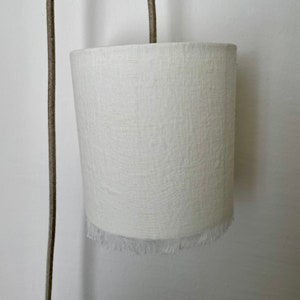 Ivory linen portable lamp. The delicacy of washed linen is found on these portable lamps highlighted with fine retro-style fringes. image 3