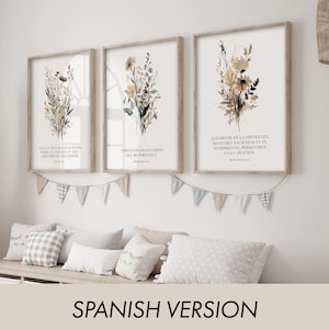 May include: Three framed floral art prints with inspirational text in Spanish. The prints feature watercolor-style botanical illustrations in neutral tones. A garland of small fabric flags hangs below the prints, and pillows are arranged on a bench.
