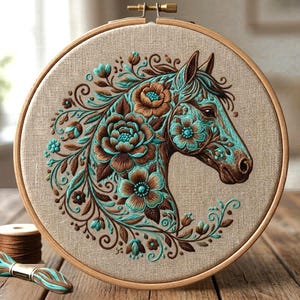 May include: An embroidered horse head design in a wooden hoop. The horse is decorated with teal and brown floral patterns. The embroidery is set in a round wooden hoop, showcasing a blend of textures and colours.