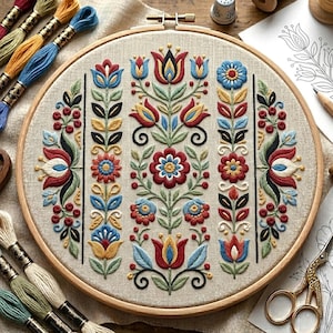 May include: A circular wooden embroidery hoop containing a beige fabric panel with a symmetrical floral design. The embroidery features vertical rows of stylised flowers, leaves, and berries in red, blue, yellow, and green thread on linen.