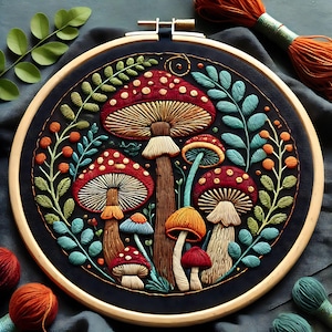 May include: Embroidered hoop art featuring a whimsical forest scene with mushrooms of various colors and sizes, including red, orange, and white, surrounded by green leaves and berries on a dark blue background.