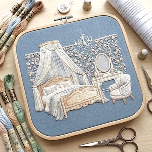 May include: A detailed embroidery of a bedroom scene, featuring a bed with a canopy, a vanity, and a chair, all in soft, pastel colors. The artwork is framed in a wooden hoop, with spools of thread and embroidery tools surrounding it.