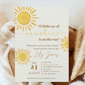 May include: A baby shower invitation featuring watercolour sun designs. The text reads "A little ray of sunshine is on the way!" and includes event details like the date, time, and location.