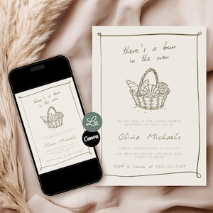May include: A baby shower invitation with the text "there's a bun in the oven" and a basket illustration. The invitation is on a smartphone and a physical card. The card includes the name Olivia Michaels, date, time, and RSVP information.