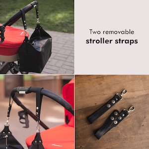 K&ouml;nnte beinhalten: Zwei schwarze Leder-Kinderwagenriemen mit silbernen Metallschnallen und Druckkn&ouml;pfen. Die Riemen sind an einem roten Kinderwagen befestigt.
