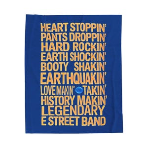 May include: A rectangular blue blanket featuring yellow text that reads: HEART STOPPIN' PANTS DROPPIN' HARD ROCKIN' EARTH SHOCKIN' BOOTY SHAKIN' EARTHQUAKIN' LOVE MAKIN' TAKIN' HISTORY MAKIN' LEGENDARY E STREET BAND, with a small blue circular icon.