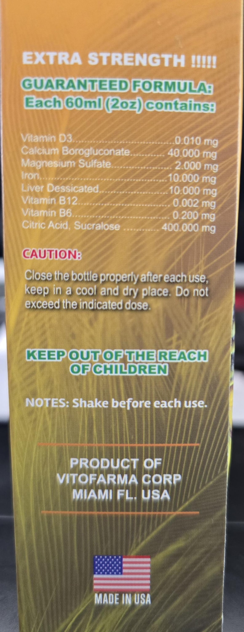 May include: A product label with text including "EXTRA STRENGTH" and a list of ingredients per 60ml (2oz) serving. The label also includes a caution, notes, and the product's origin in Miami, FL, USA, with a "MADE IN USA" label.