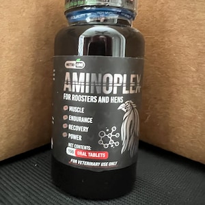 May include: A black bottle with a white label that says "Aminoplex for Roosters and Hens". The label also lists the benefits of the product, which include muscle, endurance, recovery, and power. The bottle contains 100 oral tablets and is for veterinary use only.