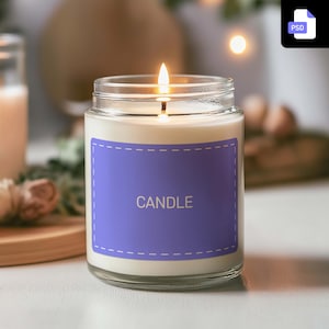 May include: A lit candle in a clear glass jar with a purple label that reads "CANDLE" in white. The candle has a white wax interior and a glass lid. The background is blurred, with hints of greenery and warm lighting.