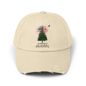 May include: A distressed beige baseball cap featuring a green pine tree design. The tree is surrounded by a faded American flag and the text "An Appeal to Heaven".