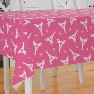 May include: Pink plastic tablecloth with a white Eiffel Tower and heart pattern.