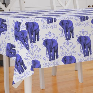 May include: A white tablecloth with a blue damask pattern and blue elephant illustrations.