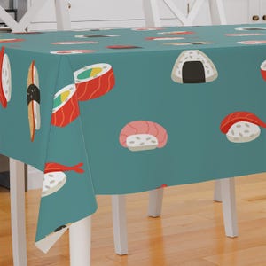 May include: A teal tablecloth with a repeating pattern of sushi rolls, salmon nigiri, and onigiri. The tablecloth is on a white table with white chairs.