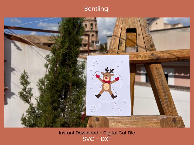 May include: A white card featuring a reindeer angel design with a red scarf and mittens, surrounded by snowflakes. The card is displayed on a wooden structure with the text "Bentling" at the top and "Instant Download - Digital Cut File SVG - DXF" at the bottom.