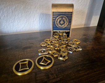 May include: A gold and black dice tower with a black and gold symbol on the front. The tower is open and spilling out gold and black dice with numbers on them.