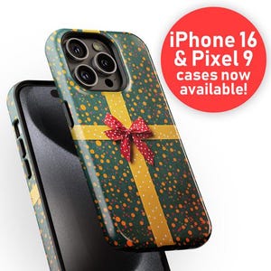 May include: A green phone case with a yellow ribbon and red bow on a green and yellow polka dot background. The case has a camera lens cutout and the text "iPhone 16 & Pixel 9 cases now available!" is in a red circle.
