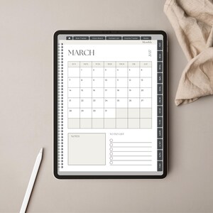 May include: A digital tablet displaying a March 2027 monthly calendar planner page with a spiral binding graphic, a notes section, and a to-do list. The interface includes side tabs for navigation and a white stylus is positioned near the tablet.