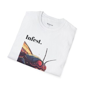 May include: White t-shirt featuring a graphic of a large insect with red eyes and the text "Infest." printed in black.