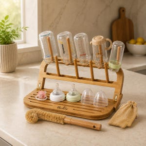 May include: A bamboo baby bottle drying rack with the brand name BuKei printed on the base. It holds five clear bottles, two bottle nipples with rings, two clear bottle caps, one pacifier, a wooden bottle cleaning brush, and a small fabric bag.