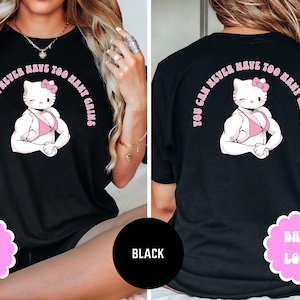 May include: Black t-shirt with a pink cartoon of a muscular Hello Kitty wearing a pink bikini and the text "You can never have too many gains".
