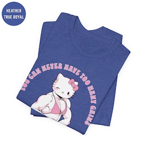 May include: A blue t-shirt with a pink Hello Kitty graphic. The graphic shows Hello Kitty with large muscles and wearing a pink bikini. The text "You can never have too many gains" is written in a pink circle around Hello Kitty.
