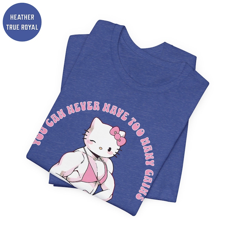 May include: A blue t-shirt with a pink Hello Kitty graphic. The graphic shows Hello Kitty with large muscles and wearing a pink bikini. The text "You can never have too many gains" is written in a pink circle around Hello Kitty.