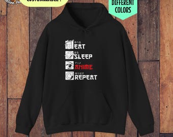 Puede incluir: Sudadera con capucha negra con un gráfico blanco que dice "Comer, Dormir, Anime, Repetir" en inglés y japonés.
