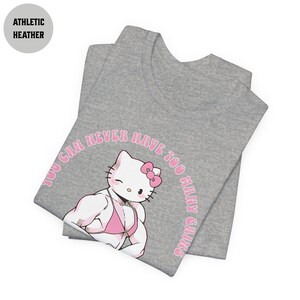 May include: A gray t-shirt with a pink Hello Kitty graphic. The graphic shows Hello Kitty with large muscles and the text "You can never have too many gains".